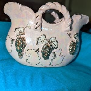Pink iridescent colored  vase with handles. Grapes in gold tone. I didn't say no
